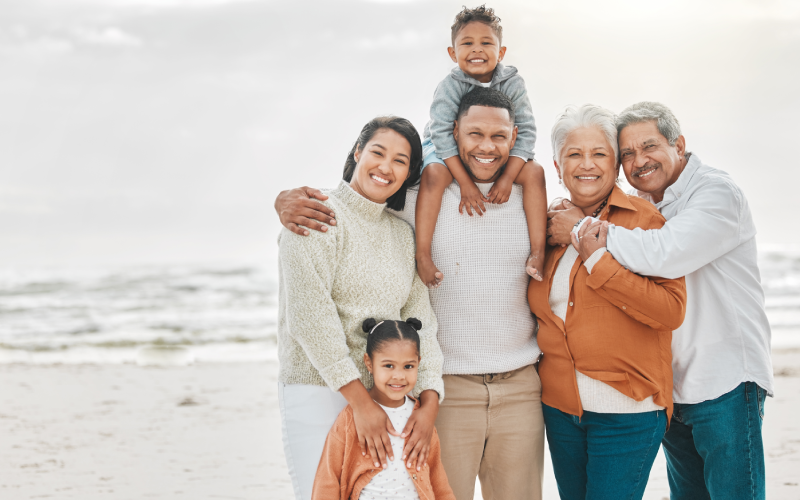 A group of people standing on top of a beach.